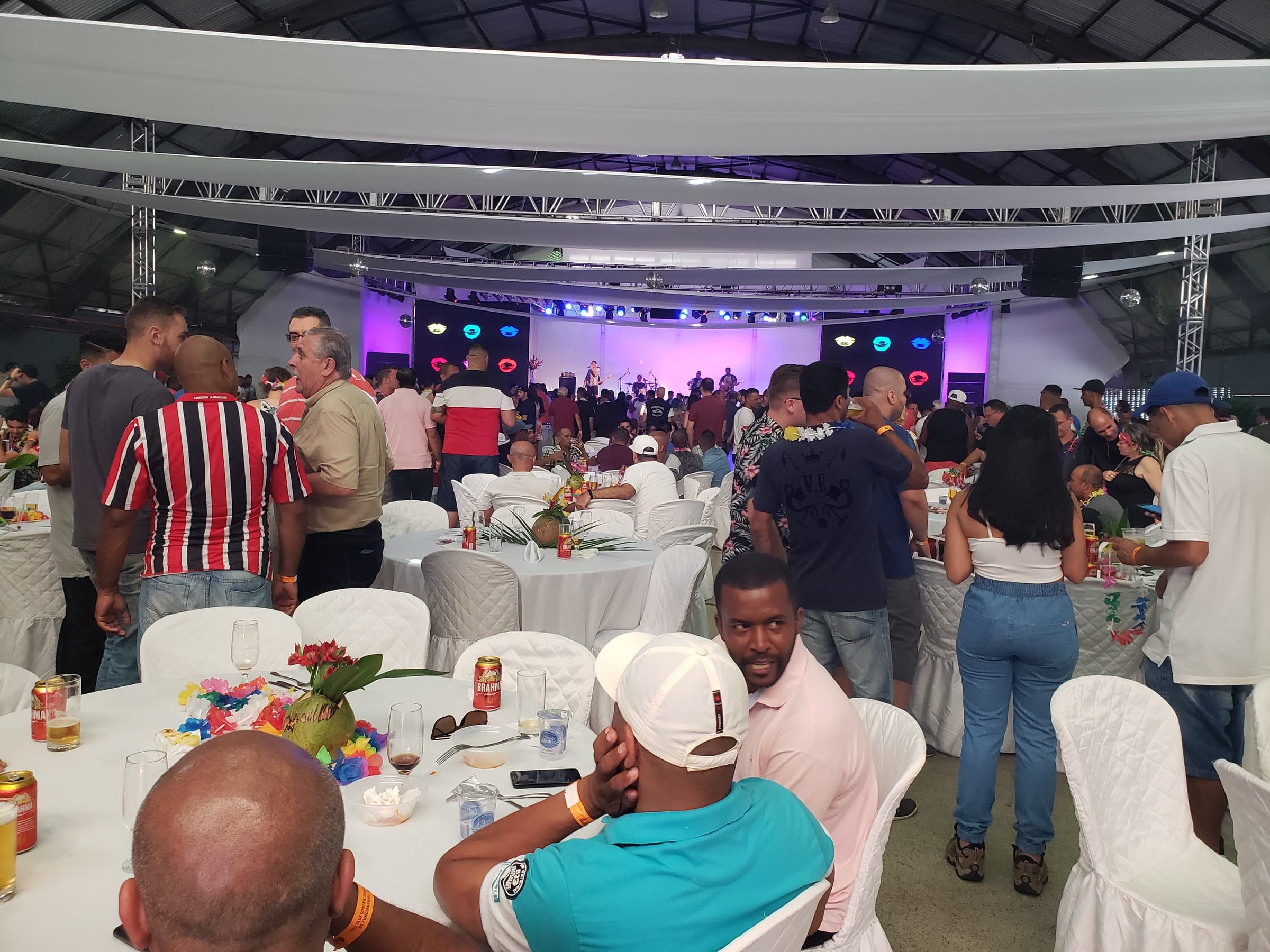 Outro ângulo da confraternização, com o palco e a estrutura de iluminação.